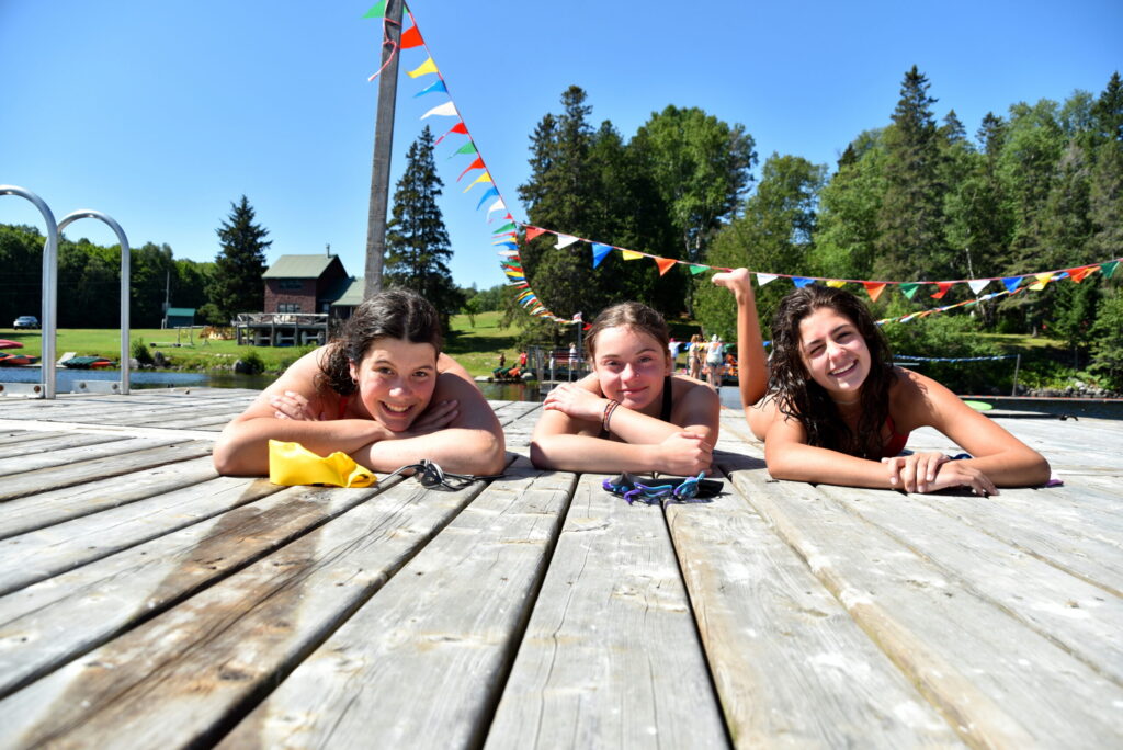 3 Girls smiling, laying on dock