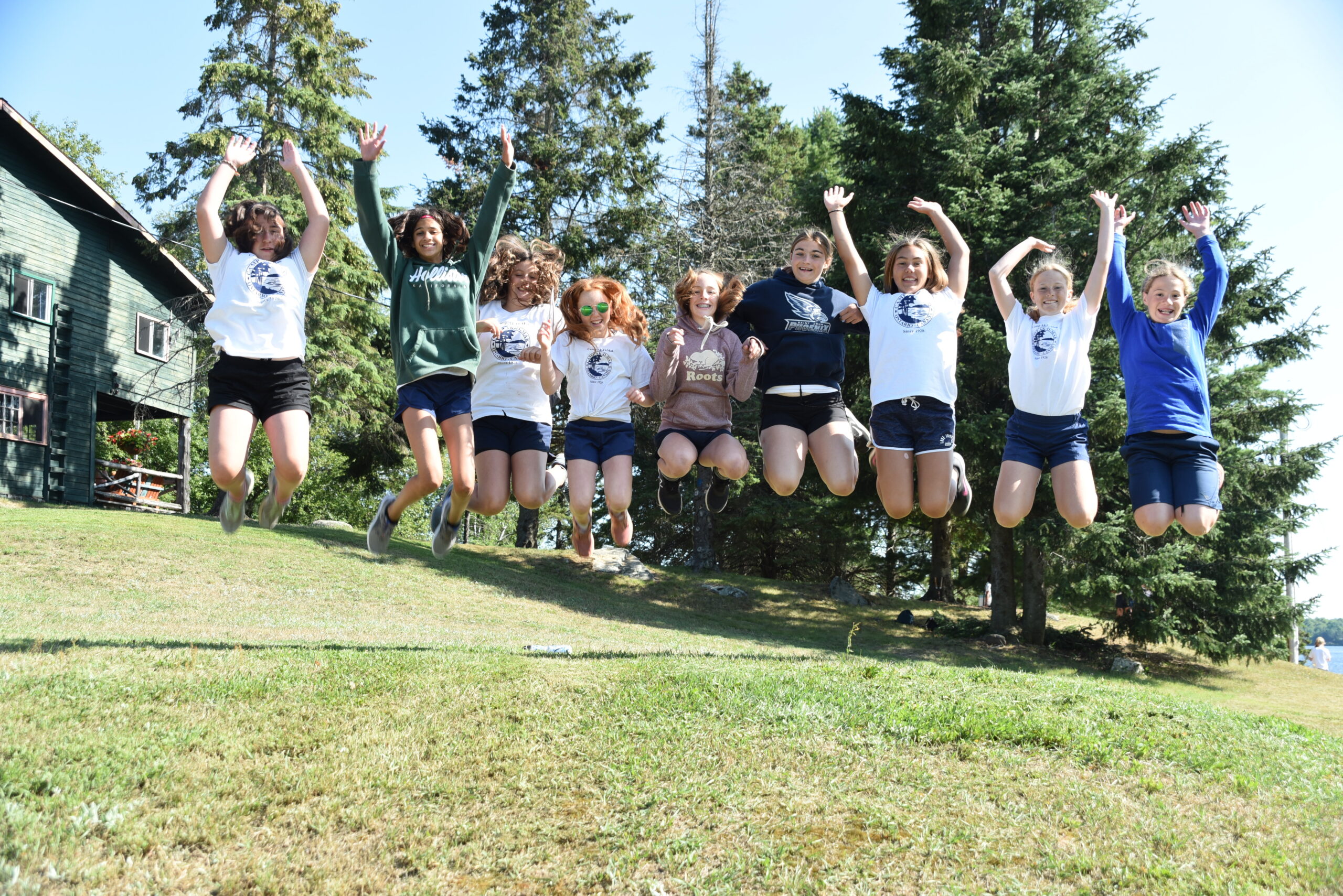 Group of campers jumping and smiling